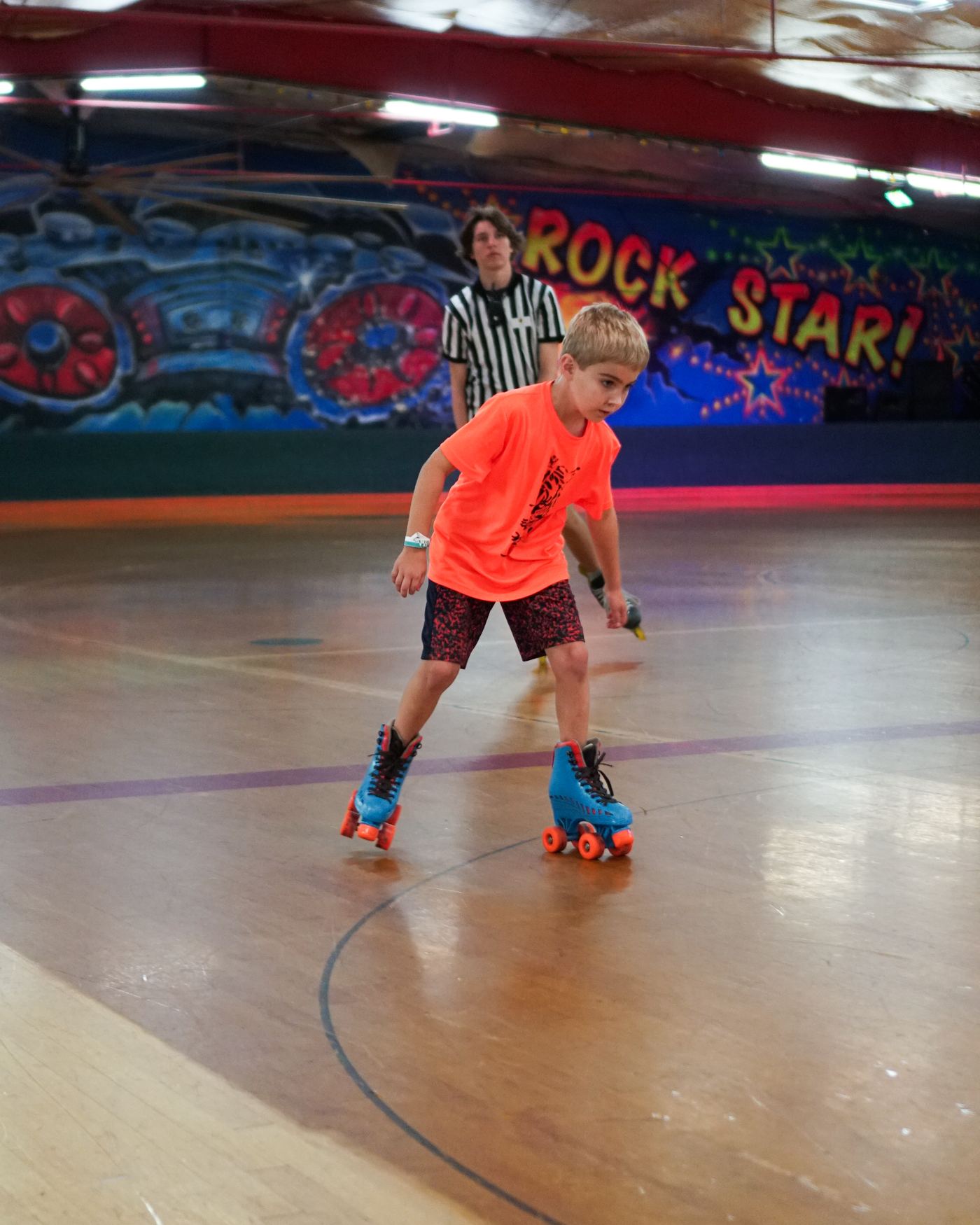 A summer camper roller skating on a Traditional TaeKwon-Do Center field trip