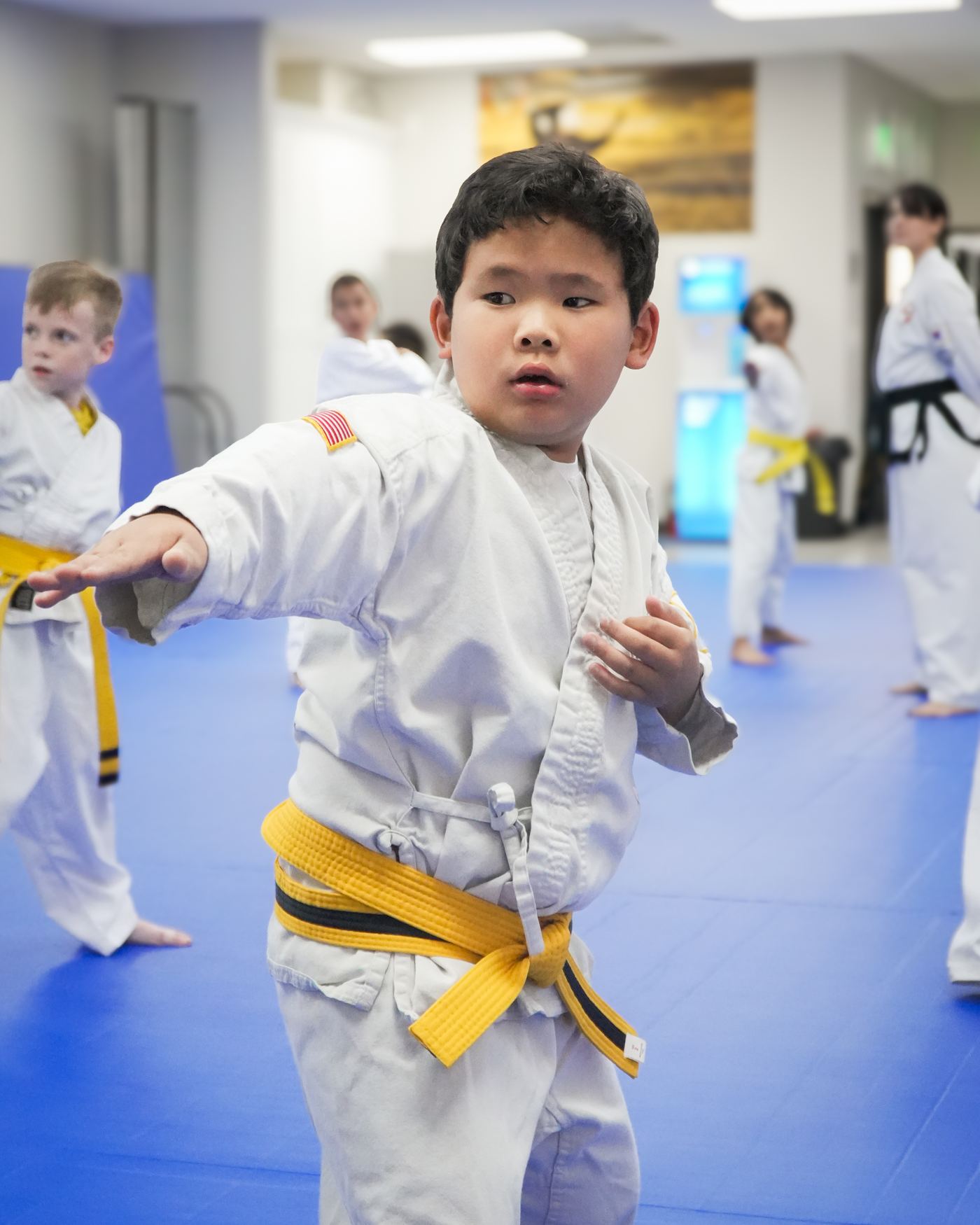 A young student in a yellow belt practicing a punch at Traditional TaeKwon-Do Center