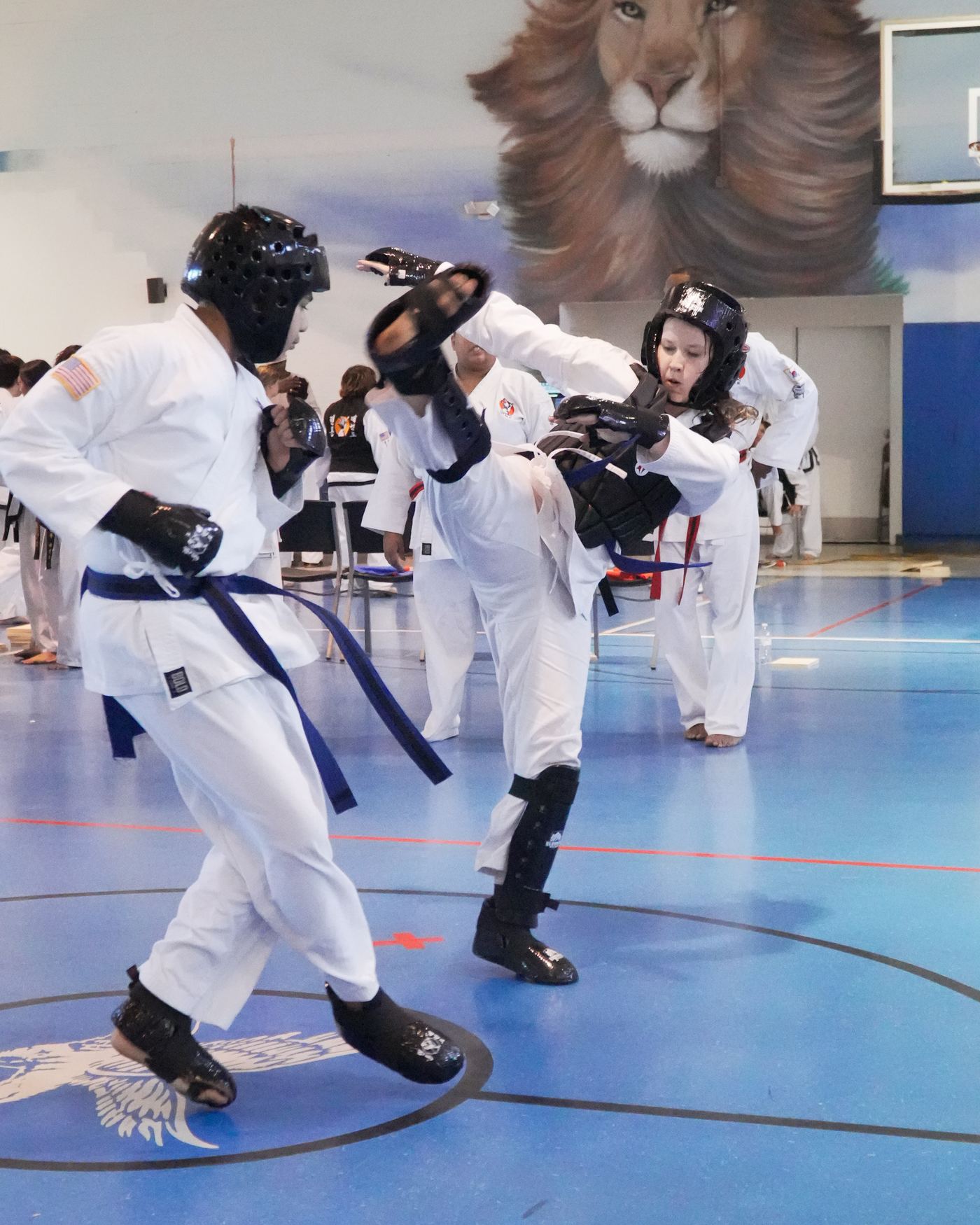 Teen students in sparring gear at a Traditional TaeKwon-Do Center tournament