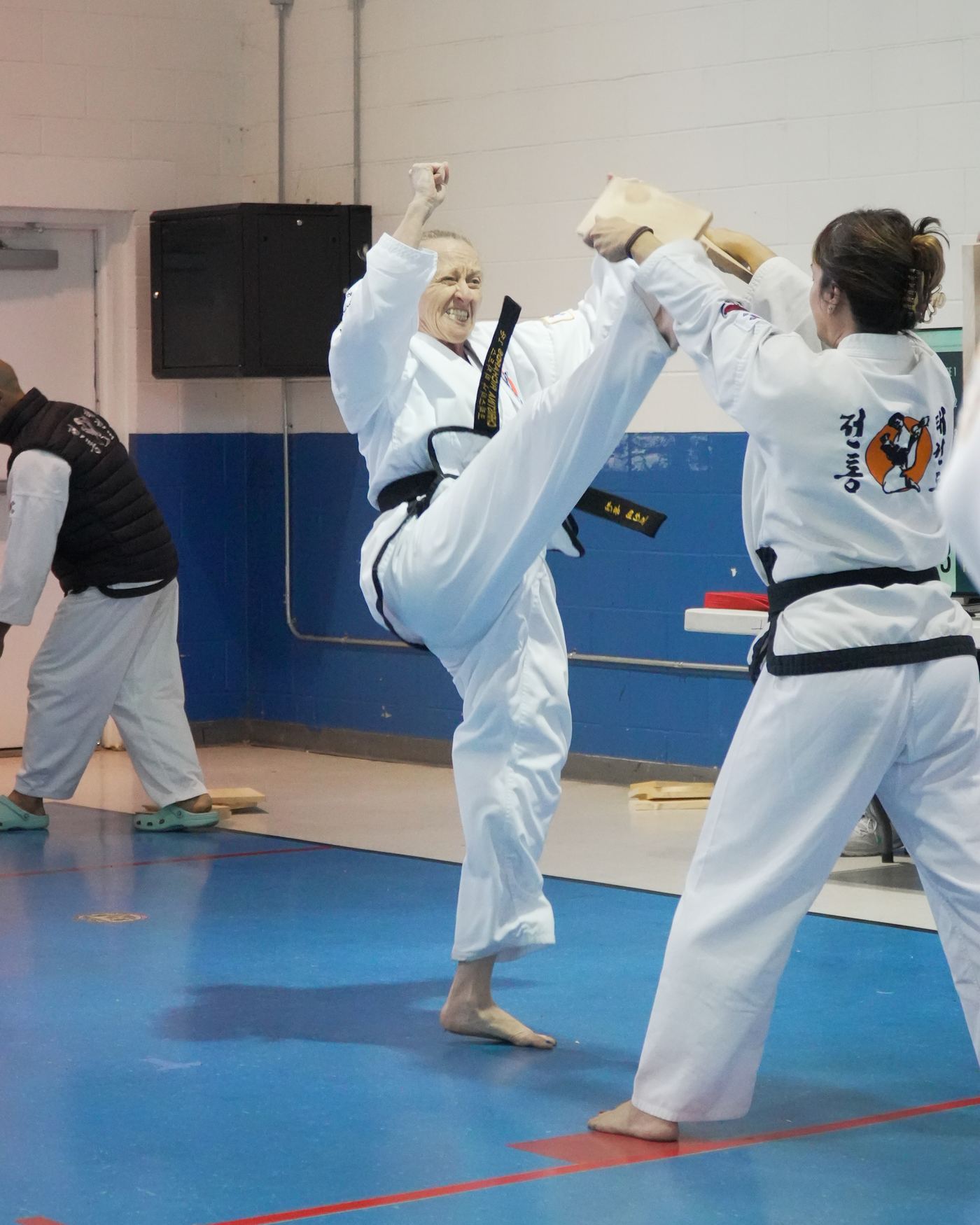 A black belt breaking a board during a rank test at Traditional TaeKwon-Do Center